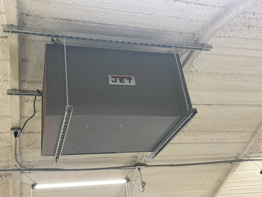 A ceiling-mounted JET industrial air purifier installed by Erman Mechanical in Fort Wayne, IN