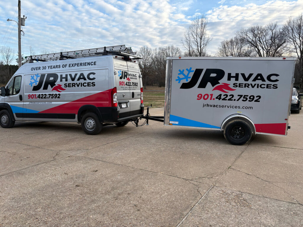 A JR HVAC Services branded service van with ladders and a matching trailer, ready for jobs in Memphis, TN.