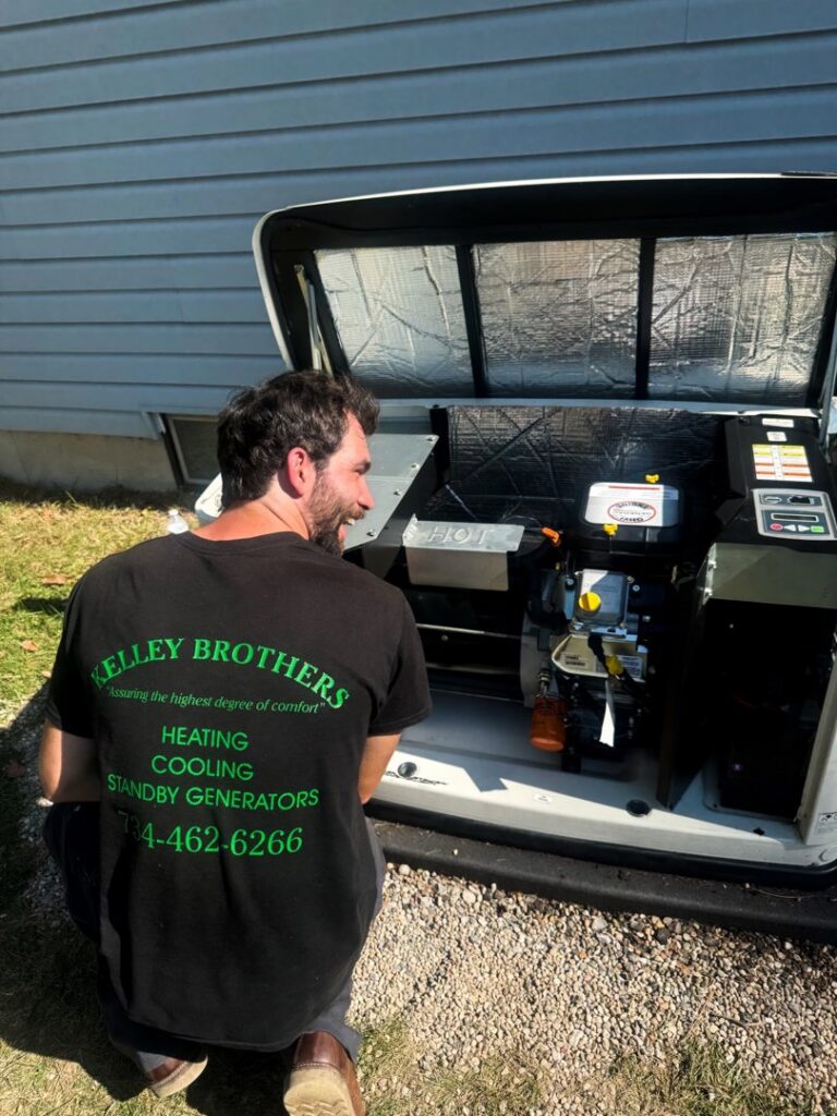 A Kelley Brothers LC technician performing repair work on an open Generac standby generator in Livonia, MI.