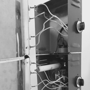 Close-up of internal electrical components and wiring during a kiln repair by Electric Rivers in Athens, GA