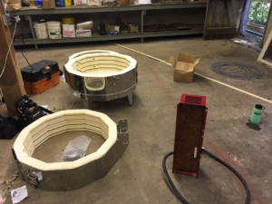 Two kilns disassembled for repair or maintenance in the workshop of Electric Rivers in Athens, GA