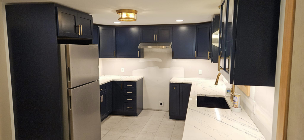 Full kitchen view showcasing new ceiling light and appliance outlets installed by Steven Polom, Journeyman Electrician in Springfield, MA.