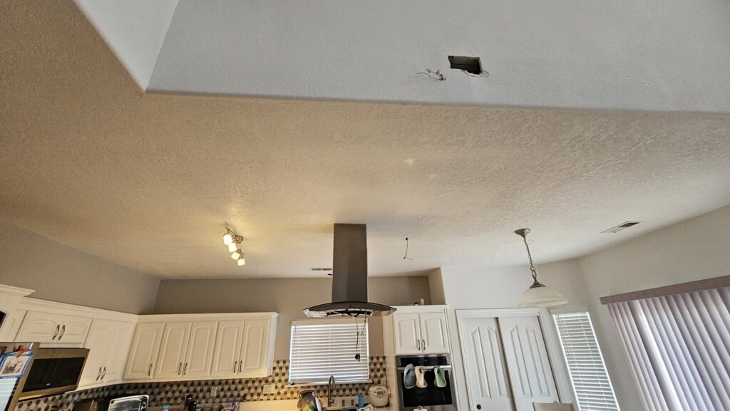 Kitchen ceiling with holes and wiring prepared for recessed lighting installation by V Electrical LLC in Albuquerque, NM.