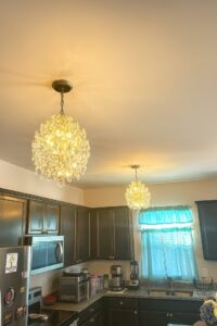 Two chandeliers and recessed lighting installed in a kitchen by Onsite Electrical Services in Raleigh, NC.