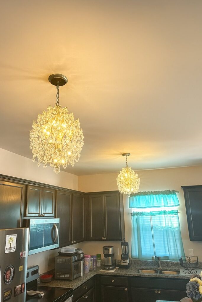 Two chandeliers and recessed lighting installed in a kitchen by Onsite Electrical Services in Raleigh, NC.