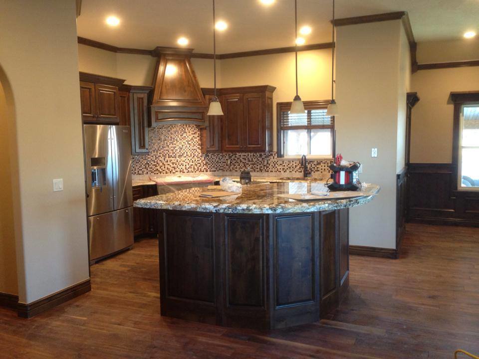 Newly installed dark wood flooring in a kitchen by Carpets By Cal Inc in Vernal, UT