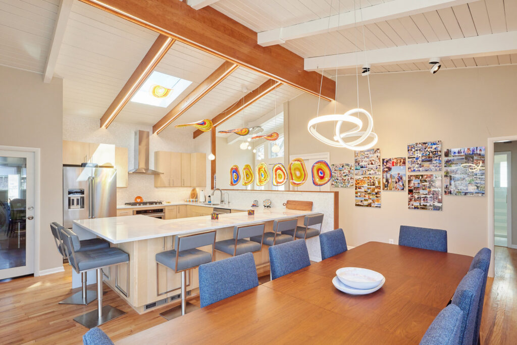 Modern kitchen and dining room with various lighting fixtures installed by Pure Light Electric in Kansas City, MO.