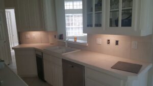 Kitchen counter with under-cabinet lighting and exposed electrical boxes for outlets and switches, showing electrical work by AK Electrical, LLC in Mesquite, TX.