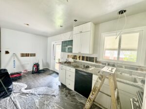 Kitchen electrical rough-in during renovation with exposed wires and ladder by P.H. Electric in Soulsbyville, CA.