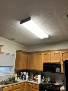 A long fluorescent light fixture installed in a kitchen ceiling by Steadfast Electric, LLC in Baton Rouge, LA.