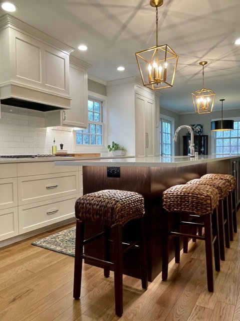 Kitchen island with modern pendant lighting and integrated power outlets installed by Kavanagh Electric in Fresno, CA.