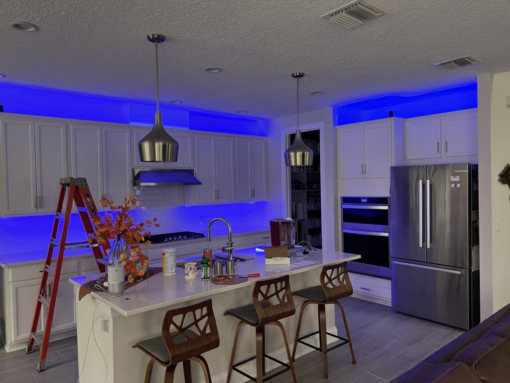 Kitchen showcasing cool blue LED strip lighting installed above and below cabinets by T.E.C Electrical Contracting, LLC in Jacksonville, FL