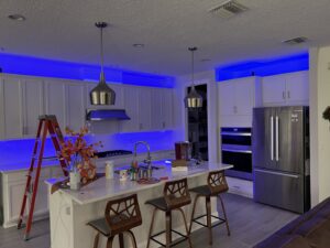 Kitchen showcasing cool blue LED strip lighting installed above and below cabinets by T.E.C Electrical Contracting, LLC in Jacksonville, FL