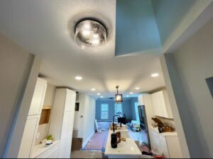 A kitchen area featuring a new light fixture and recessed lighting installed by Royal Electric Services in Raleigh, NC