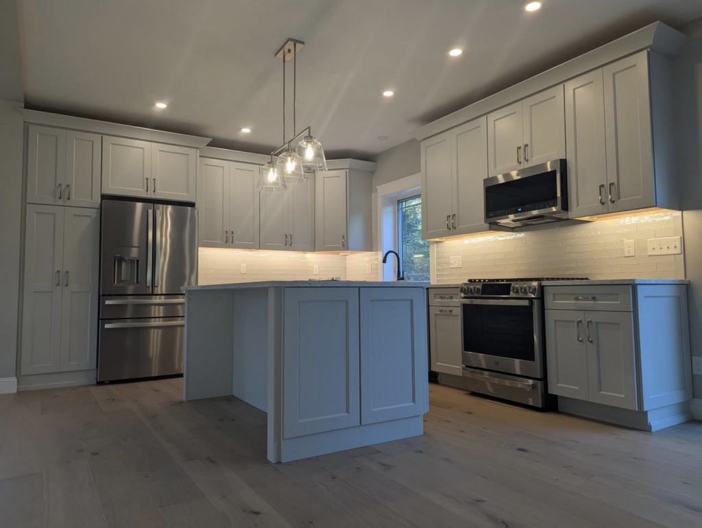 Newly installed kitchen lighting and appliance wiring by Daigle Electric in Barrington, NH, featuring pendant and under-cabinet lights.