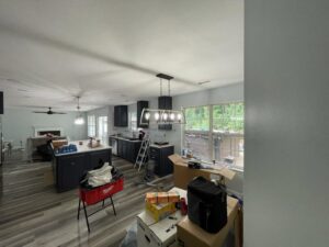 Kitchen lighting installation in progress, showing a linear chandelier and recessed lights by Denny Power Solutions in Virginia Beach, VA