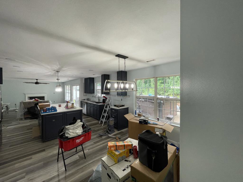 Kitchen lighting installation in progress, showing a linear chandelier and recessed lights by Denny Power Solutions in Virginia Beach, VA