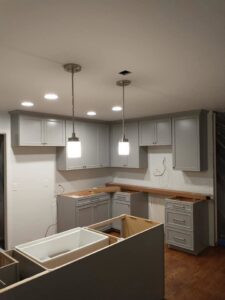 Newly installed pendant and recessed lighting in a kitchen under construction by J3 Services in Goose Creek, SC.