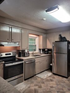 A modern kitchen featuring new overhead and under-cabinet lighting installed by Miller Electric in Summerville, SC.
