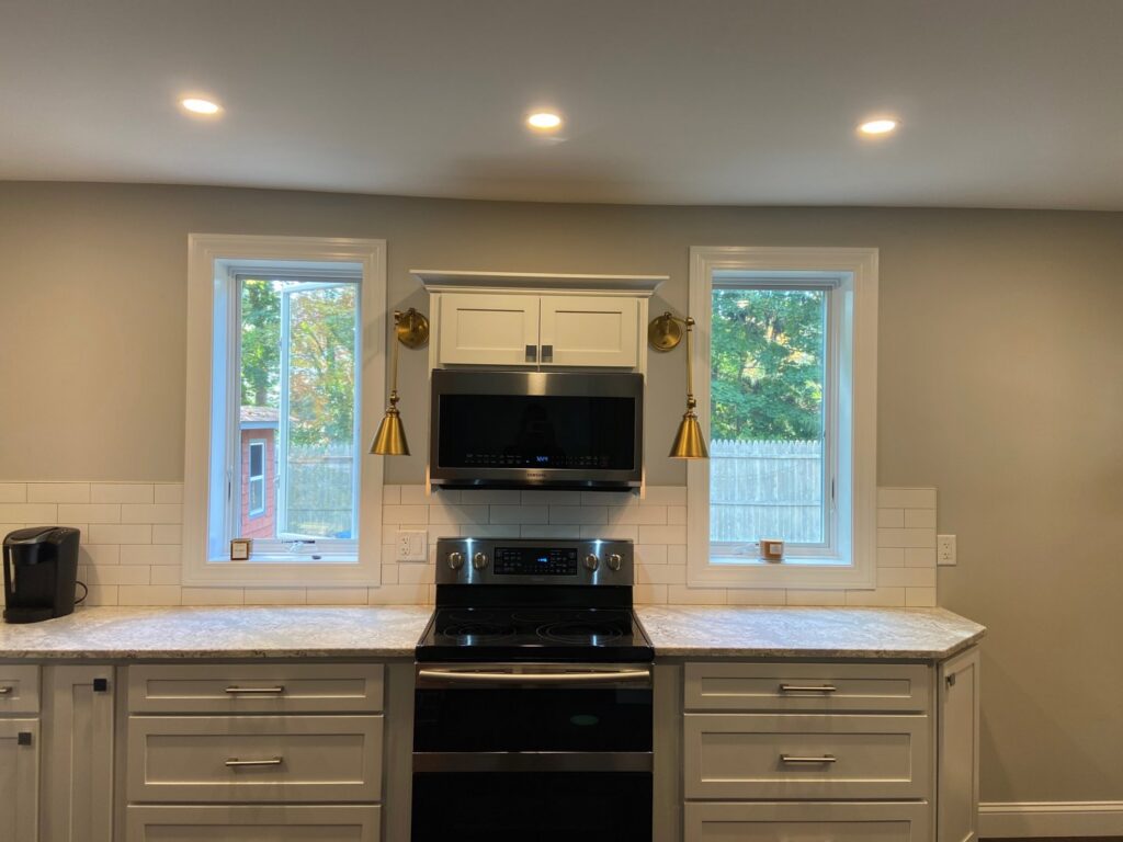 Kitchen with new recessed lighting, under-cabinet lights, and wall sconces installed by T.S.F Electric in Saco, ME.