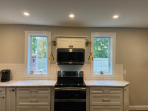 Kitchen with new recessed lighting, under-cabinet lights, and wall sconces installed by T.S.F Electric in Saco, ME.