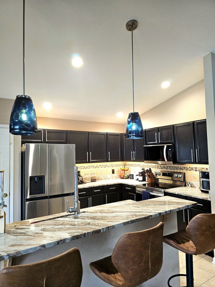 Upgraded kitchen lighting with pendant and recessed fixtures installed by Everyday Electric in Tampa, FL.