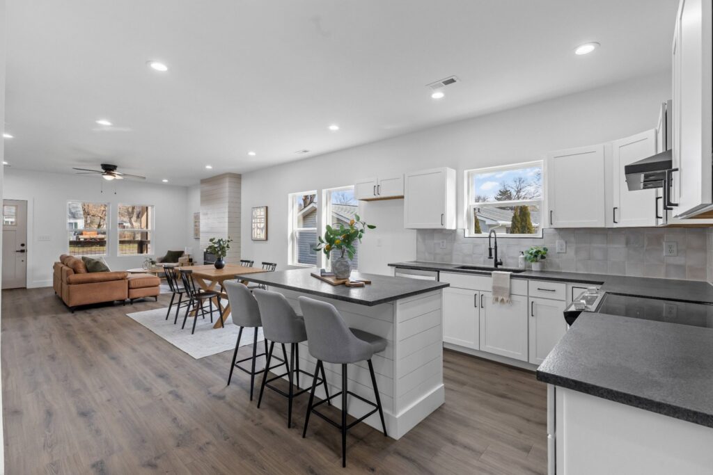 Modern kitchen and living room with recessed lighting and ceiling fan installed by Braden the handyman in Knoxville, TN