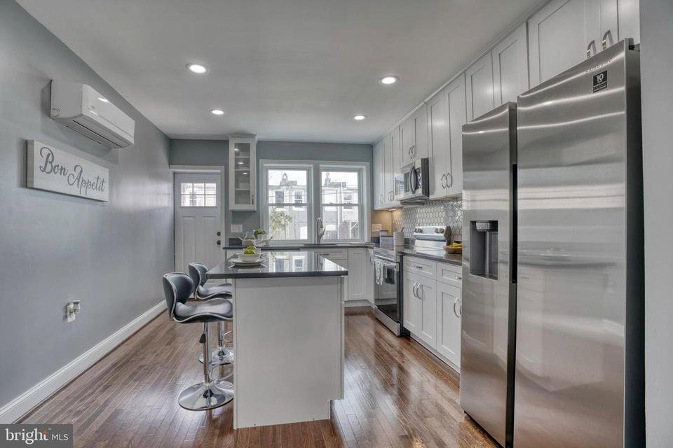 A modern kitchen featuring a wall-mounted mini-split indoor unit for efficient climate control by Simply Home Service in Gaithersburg, MD.