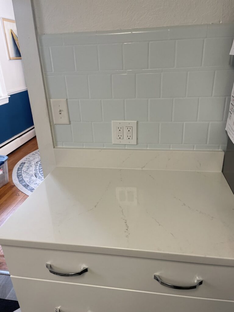 New electrical outlets and light switches installed on a kitchen backsplash by Common Ground Electrical in Baltimore, MD.