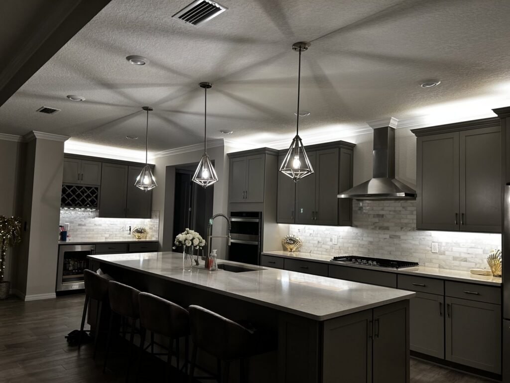 Modern kitchen with stylish pendant lights and recessed ceiling lighting by T.E.C Electrical Contracting, LLC in Jacksonville, FL