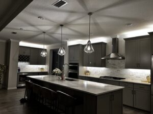 Modern kitchen with stylish pendant lights and recessed ceiling lighting by T.E.C Electrical Contracting, LLC in Jacksonville, FL