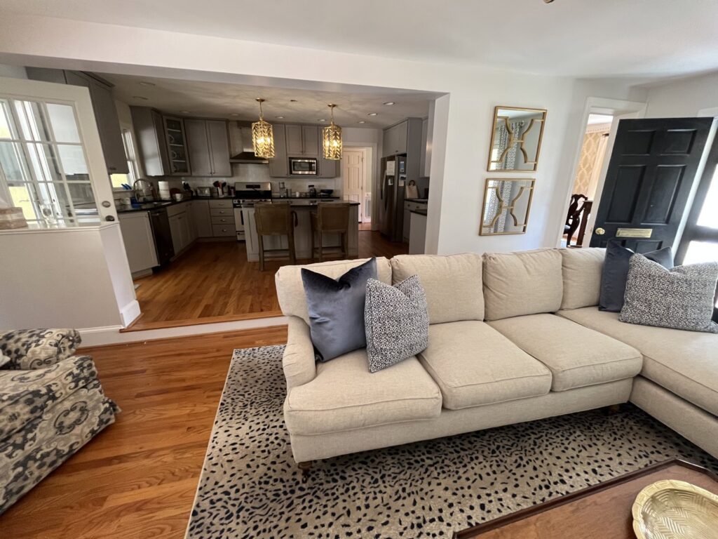 View from a living room into a kitchen with modern pendant lighting installed by All Connected Electric LLC in Raleigh, NC.