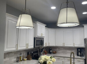 Two large pendant lights installed over a kitchen island, demonstrating lighting work by G5 Electric, LLC in Evansville, IN.