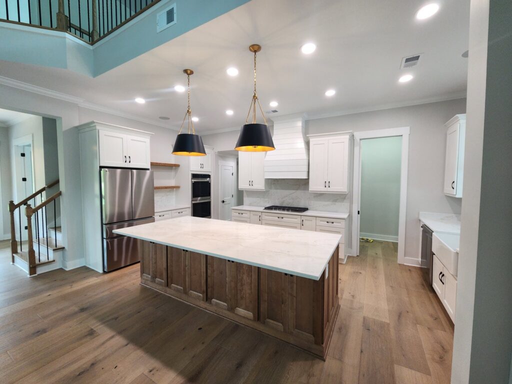 A modern kitchen with stylish pendant lights over the island and recessed lighting by ALC Electric LLC in Goose Creek, SC