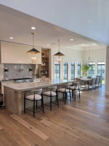 A spacious kitchen featuring stylish pendant lights and recessed ceiling lights installed by Homestead Electric in Orem, UT.