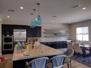 Professional installation of modern pendant and recessed lighting in a kitchen by A Helping Hand Handyman Services in Chicago, IL.