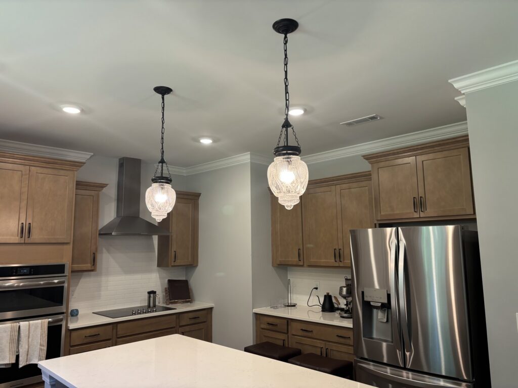 New pendant and recessed lighting installed in a kitchen by Onsite Electrical Services in Raleigh, NC.