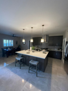 Modern kitchen with pendant lights over the island and recessed ceiling lights installed by R&M Electric LLC in Gilbert, AZ.