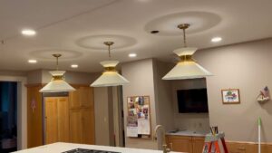 A modern kitchen featuring stylish pendant lights and recessed ceiling lights, installed by Greif Electric Company in Dolgeville, NY.