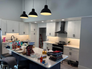 A bright kitchen showcasing new pendant, recessed, and under-cabinet lighting installed by JayCo Lighting & Electric in Colorado Springs, CO.