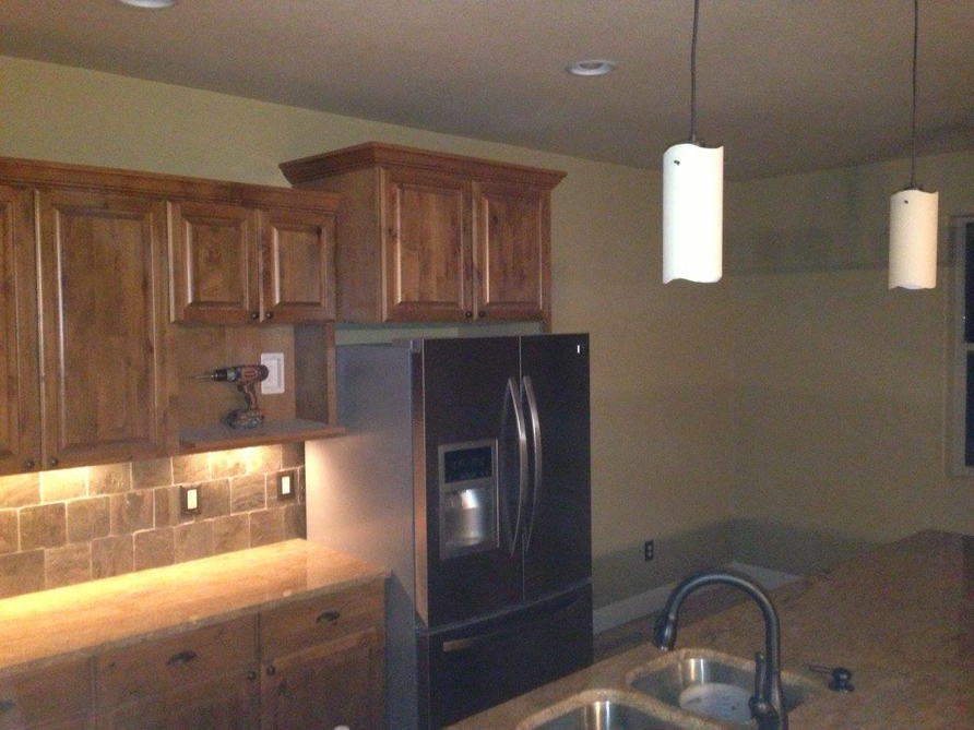 A kitchen featuring new pendant lights, under-cabinet lighting, and appliance hookups by Arc-n-Spark Electric in Cheyenne, WY.