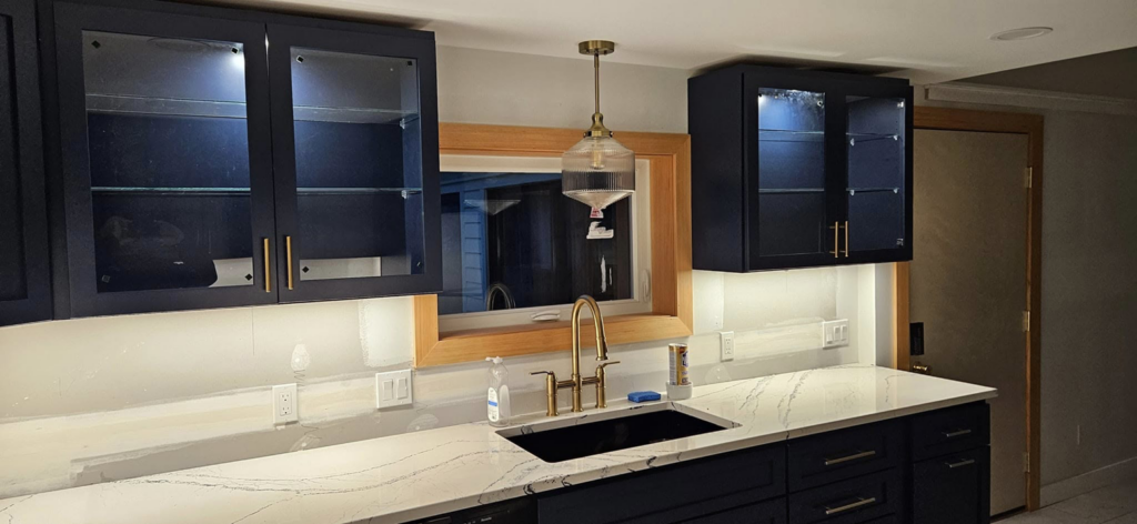 Kitchen sink area featuring a new pendant light and under-cabinet lighting by Steven Polom, Journeyman Electrician in Springfield, MA.