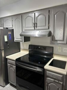 A newly installed kitchen range hood above a stove by Heritage Home Service in Worcester, MA
