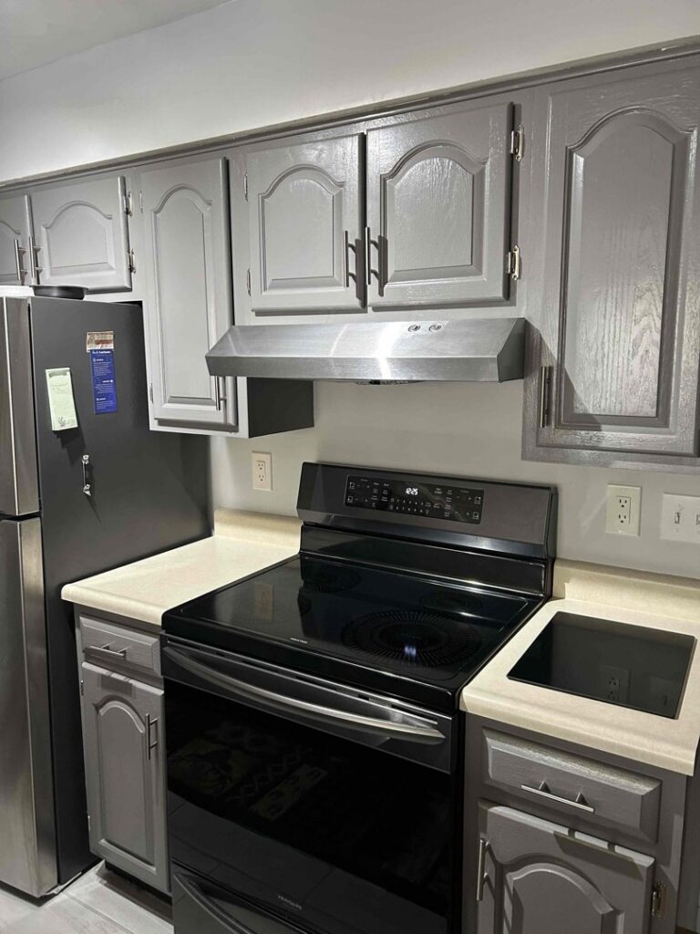 A newly installed kitchen range hood above a stove by Heritage Home Service in Worcester, MA