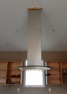 A modern kitchen range hood ventilation system installed by Atmosphere Mechanical Heating And Air / Ventilation in Aurora, CO.