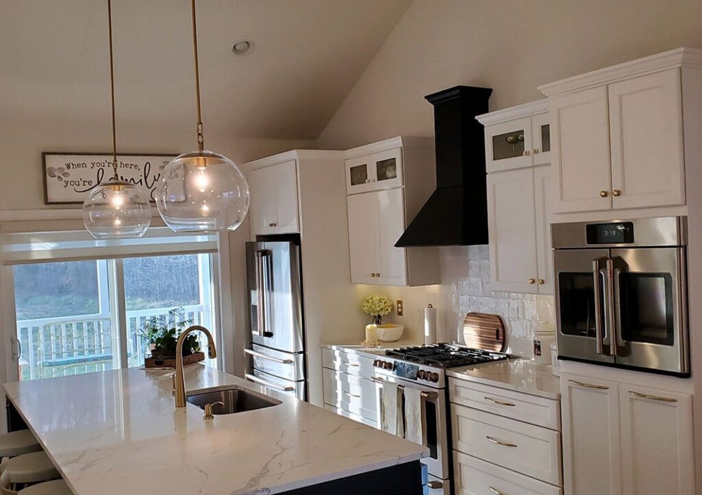 A modern kitchen featuring a newly installed range hood for ventilation, provided by L & R Electrical and HVAC Services in San Marcos, CA.