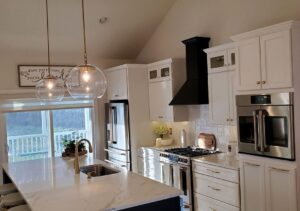 A modern kitchen featuring a newly installed range hood for ventilation, provided by L & R Electrical and HVAC Services in San Marcos, CA.