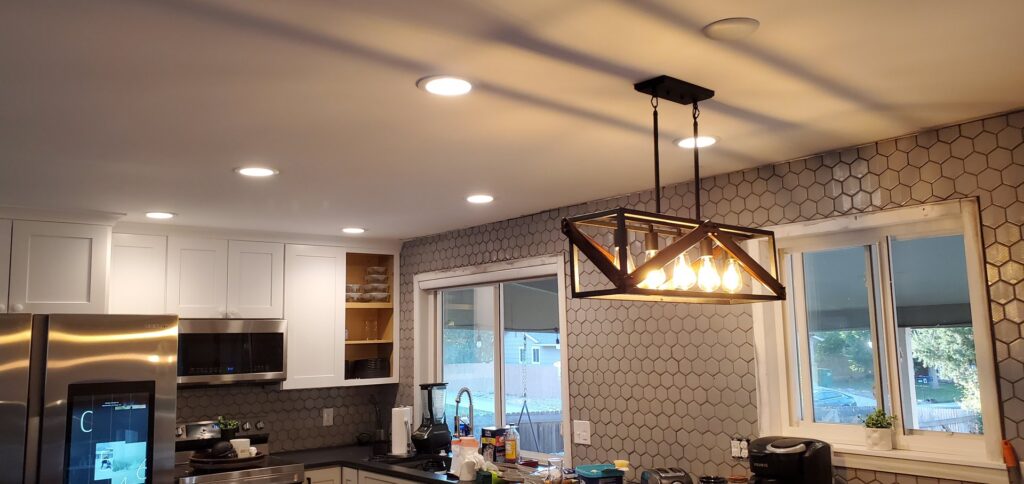 Kitchen with new recessed lighting and a modern pendant fixture installed by Midway Electric Inc. in Columbia, MO.