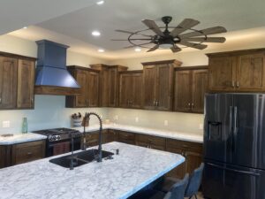 Modern kitchen with new recessed lighting and a stylish ceiling fan installed by McPhillips Electric LLC in Columbus, NE.