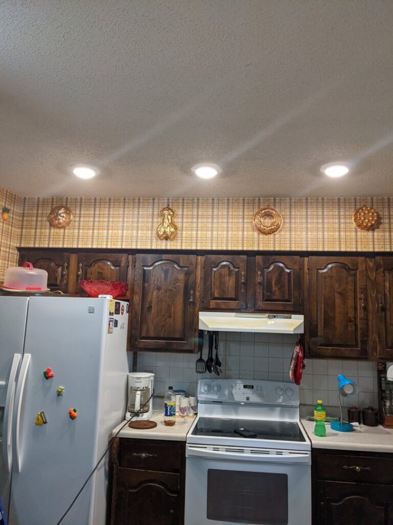 A kitchen featuring newly installed recessed lighting in the ceiling, completed by GOBE LLC in Columbia, MO.